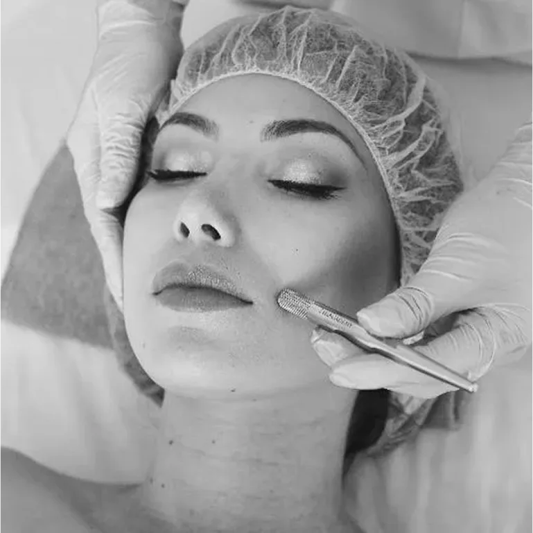 A woman receiving a cosmetic injection on her face.